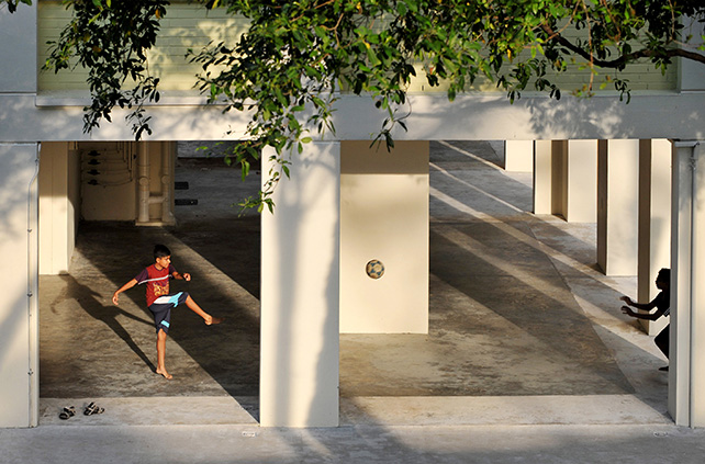Two boys kicking a soccer ball at the void deck of a block of housing apartments in Bishan in July 2012. ST Photo: Alphonsus Chern