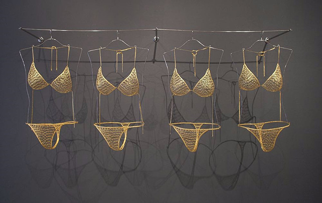 Tayeba Begum Lipi, Comfy Bikinis, 2013, brass safety pins covered with electroless nickel immersion gold, stainless steel and glass, 14.2 x 35.8 x 48 inches/36.1 x 90.9 x 121.9 cm